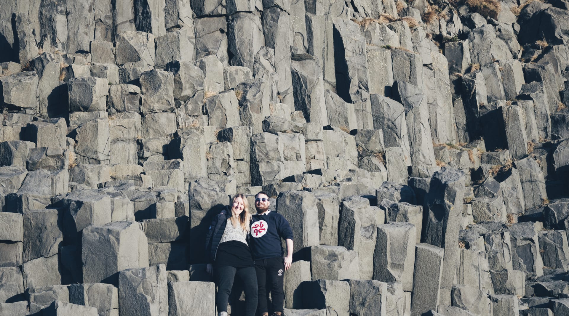 Becoming one with nature on top of basalt columns in Reynisfjara beach Iceland