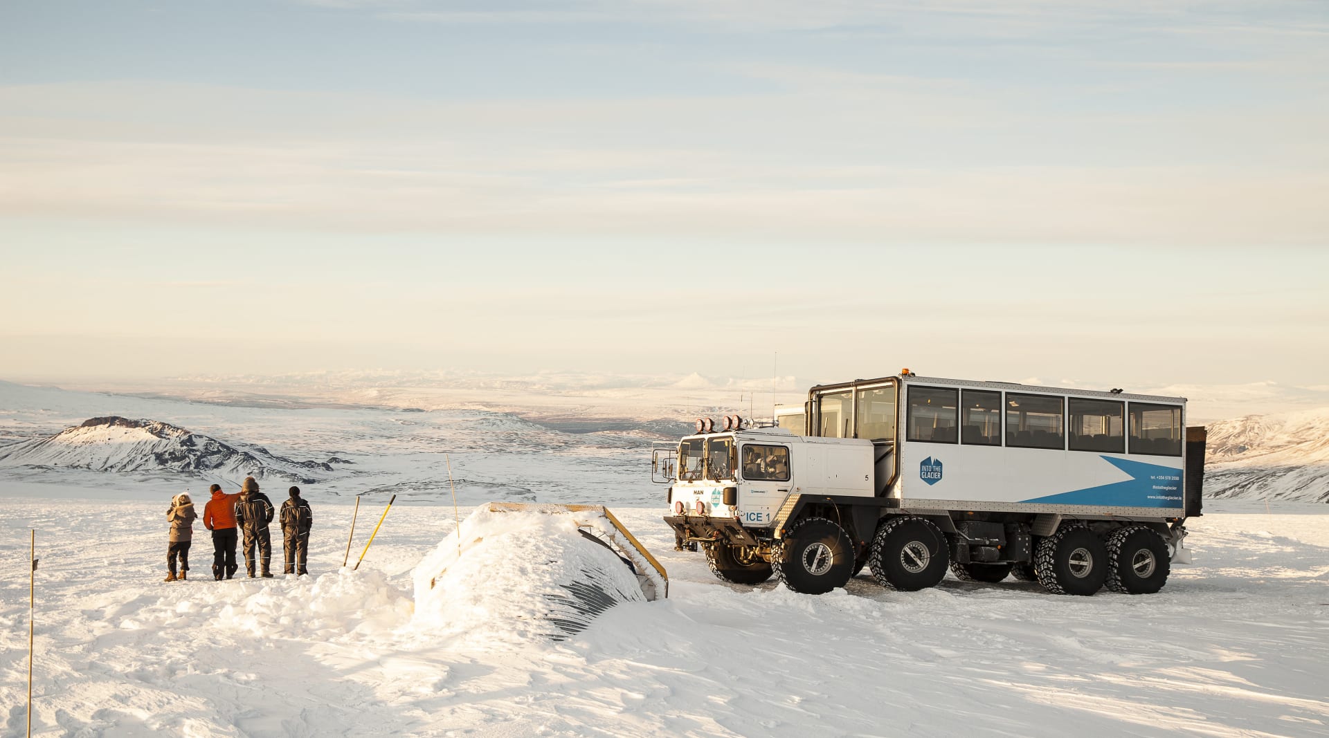 People enjoying the view next to transport for Langjokull glacier tour from reykjavik