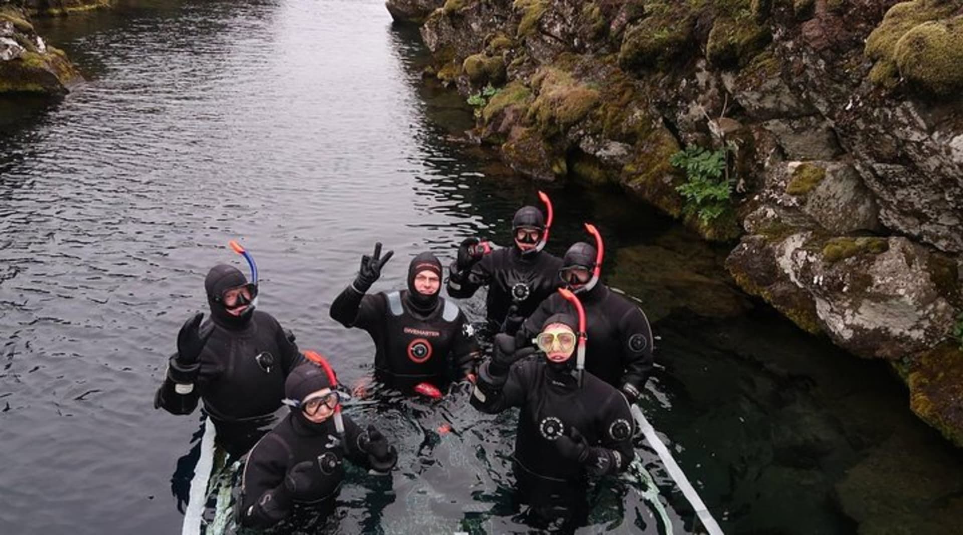 snorkelers entering Silfra