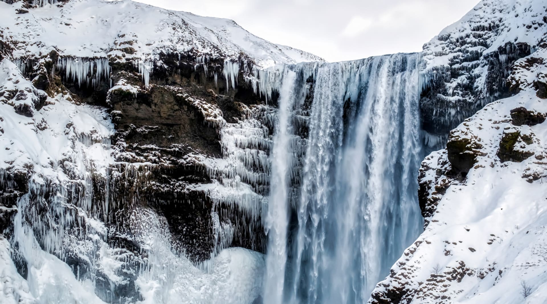 Skogafoss with ice and snow in winter