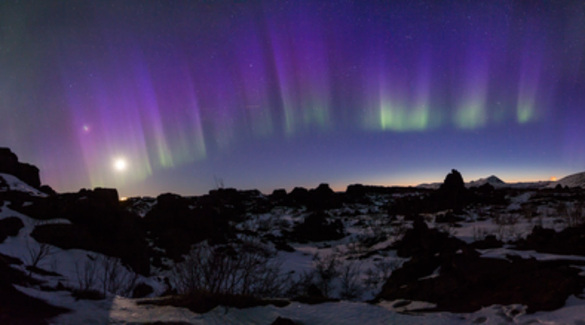 Northern Lights over cliff in Iceland