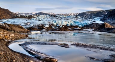 Thumbnail about Glacier with water and sand lagoon