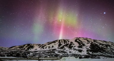 Thumbnail about Northern Lights over Mountain In Iceland