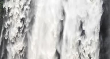 Thumbnail about Seljalandsfoss on South Shore Coast in Iceland. Man standing in front of gigantic waterfall