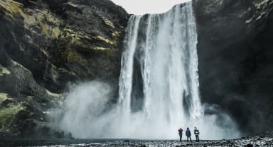 Thumbnail about People standing next to Skogafoss waterfall