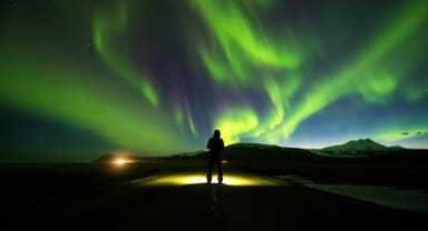 Thumbnail about Person on Road with Northern Lights