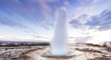 Thumbnail about Strokkur winter with blue sky sunrise