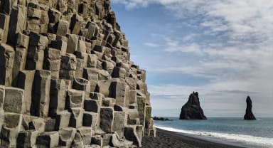 Thumbnail about Black Sand Beach with basalt columns