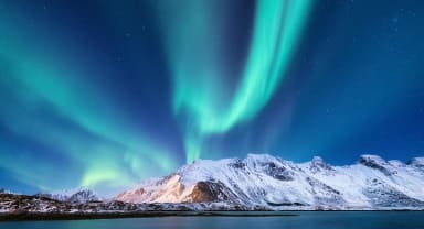 Thumbnail about Northern Lights over a snow-covered mountain in Iceland