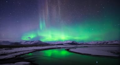 Thumbnail about The spectacular show of the Northern Lights over a snow-covered Icelandic landscape