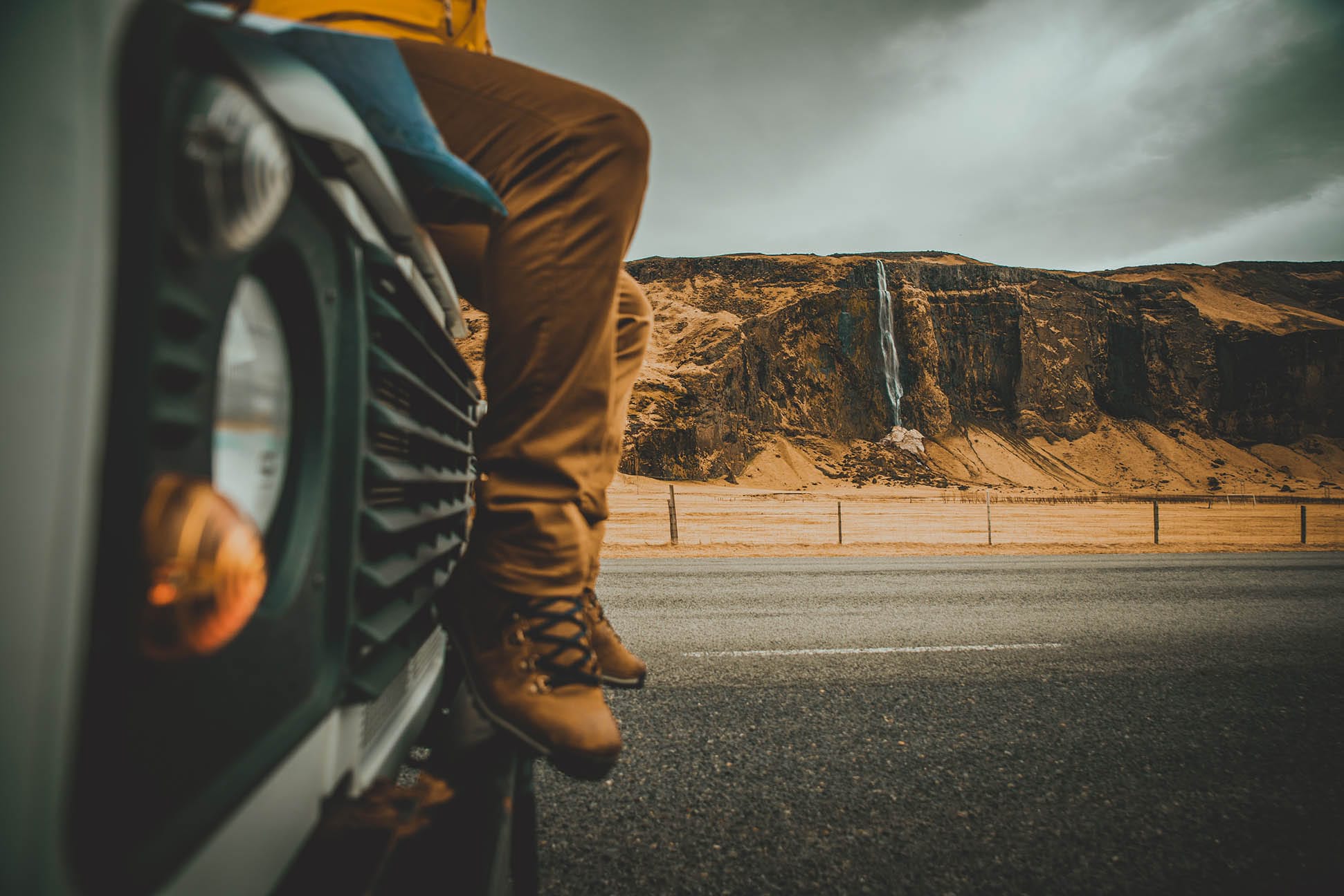 Man sitting on hood of a jeep