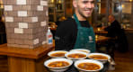 Thumbnail about A waiter carrying plates of Icelandic Meat Soup
