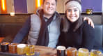 Thumbnail about A couple smiling while sampling different beers.