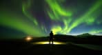 Thumbnail about Person on Road with Northern Lights