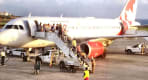 Thumbnail about Passengers are getting out of a plane on the tarmac.