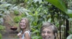 Thumbnail about Two senior travellers are thoroughly enjoying this spectacle of nature, walking through the Annandale waterfall.
