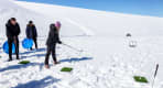 Thumbnail about person playing golf ontop the glacier, standing in white snow
