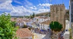 Thumbnail about Óbidos is a medieval town with cobblestone streets and flower-bedecked, whitewashed houses