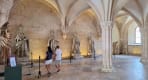 Thumbnail about Interior cloister of Alcobaça Monastery with stone statues, arches and visitors walking