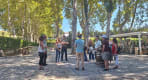 Thumbnail about Quinta da Pacheca wine estate tour with guide and guests standing among trees, barrels, and cobbled paths