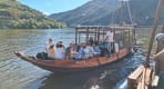 Thumbnail about Traditional rabelo boat on the Douro River near Pinhão with passengers and terraced vineyard hills