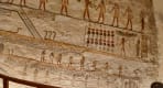 Thumbnail about A close-up view of a beige stone wall with colorful, finely carved Ancient Egyptian hieroglyphs and deities inside the tomb of Merenptah 