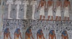 Thumbnail about Two tiers of Ancient Egyptian figures and deities painted in blue, red, and white on a stone wall 