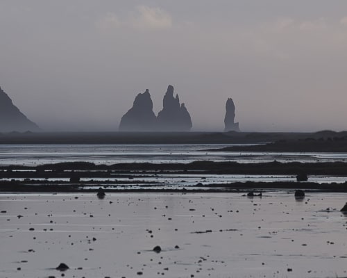 black beach meets the ocean