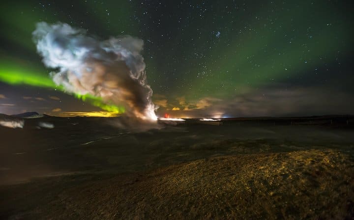 Northern Lights behind a column of steam coming from one of Iceland's largest geothermal areas.