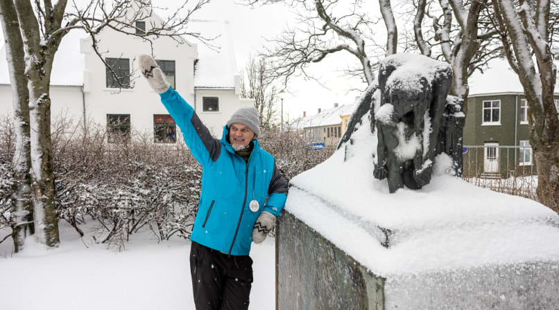 A guide from Your Friend in Reykjavik sharing a story about cats in front of a monument. 