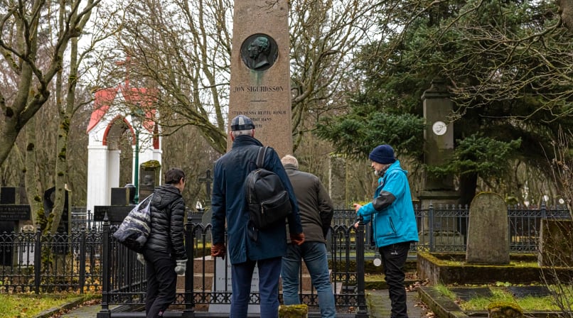 A group of guests inspecting a monument