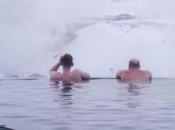 Two men enjoying the warm water of the Krauma spa's geothermal pool