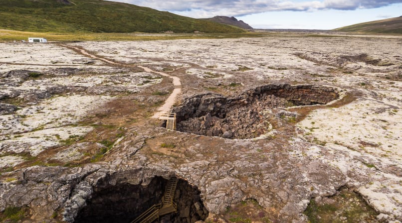 An elevated view of the caves only entrances. The accessible main entrance is visible behind the smaller "skylight".