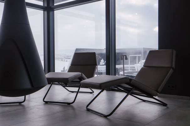 A picture of two deck chairs sitting inside the Krauma Spa