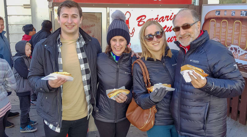 A family enjoying the Icelandic hot dog at the original food stall which dates from 1937