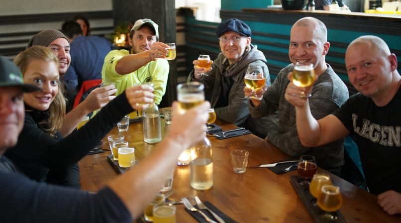 A Beer & Booze tour group performing the Skál gesture
