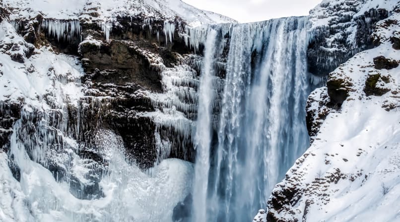 Skogafoss with ice and snow in winter