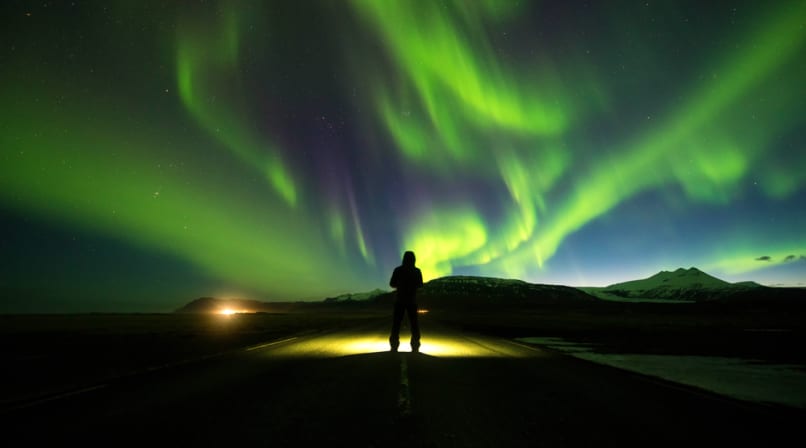 Person on Road with Northern Lights