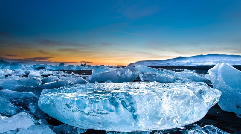 Remaining icebergs on black basalt beach near Glacier Lagoon