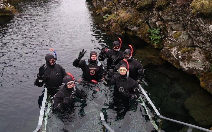 snorkelers entering Silfra