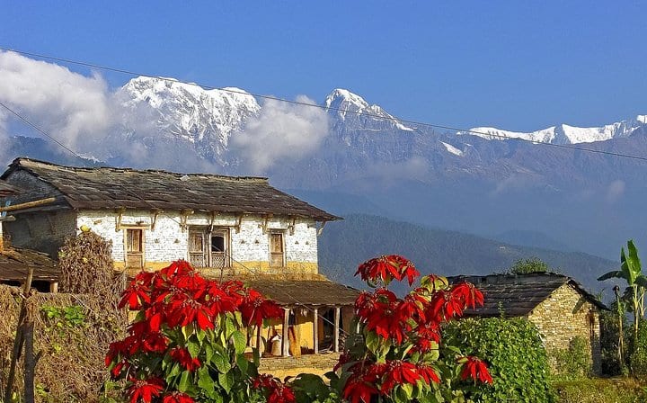 Traditional house and mountains at background.