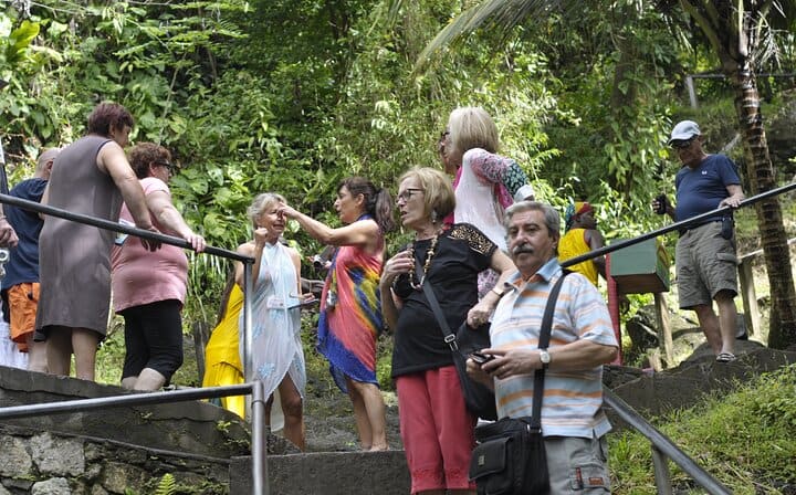 A large crowd of sightseers group at the Annandale waterfall