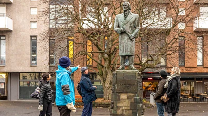 A guide from Your Friend in Reykjavik explaining the statue to a group.