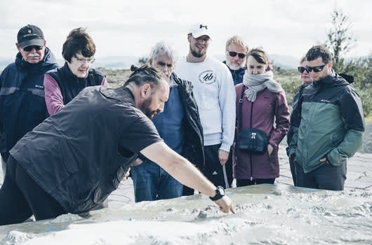 Guide giving a geology lesson at Thingvellir National Park