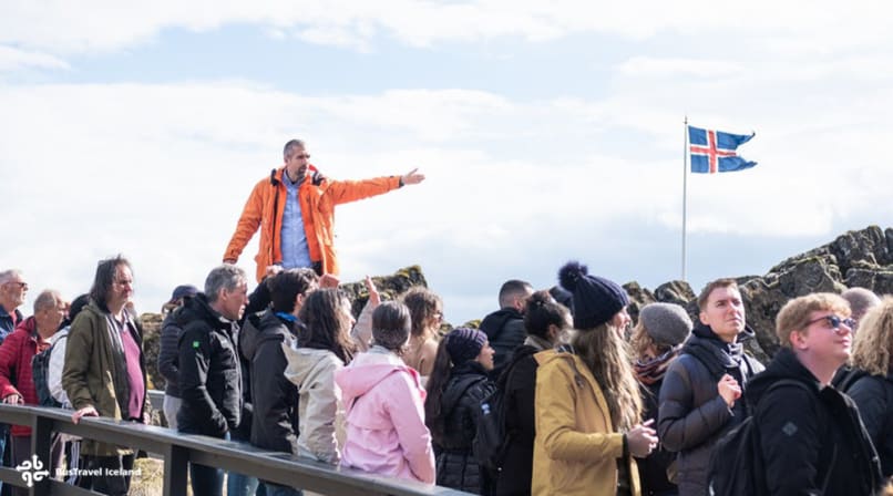 BusTravel guide leading group down Almannagjá fissure in Thingvellir National Park