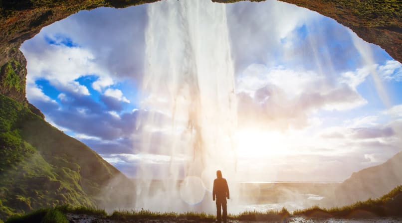 Taking in the rayons of light passing through the waters of Seljalandsfoss waterfall