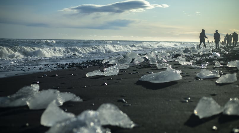 Shining ice looking like diamonds on volcanic black beach