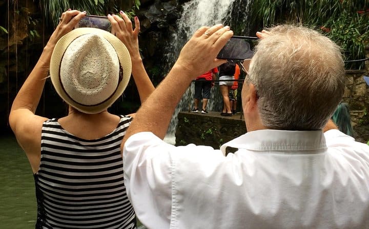 Travelers taking photos of the waterfall
