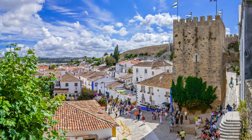 Óbidos is a medieval town with cobblestone streets and flower-bedecked, whitewashed houses