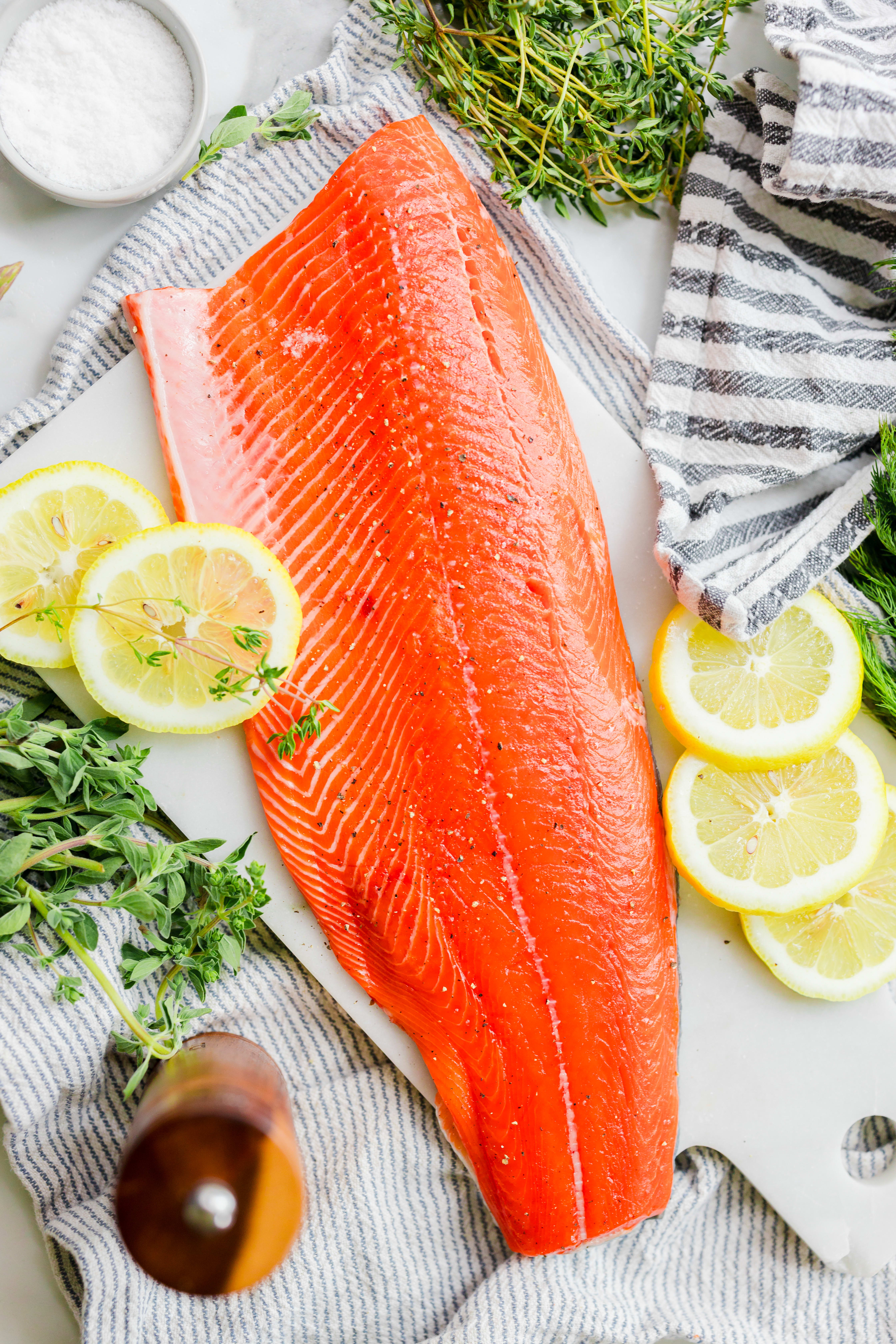 A sockeye fillet garnished with lemon slices and thyme